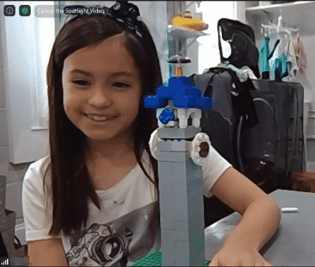 Screenshot of student smiling student showing her Big Ben creation from online LEGO class